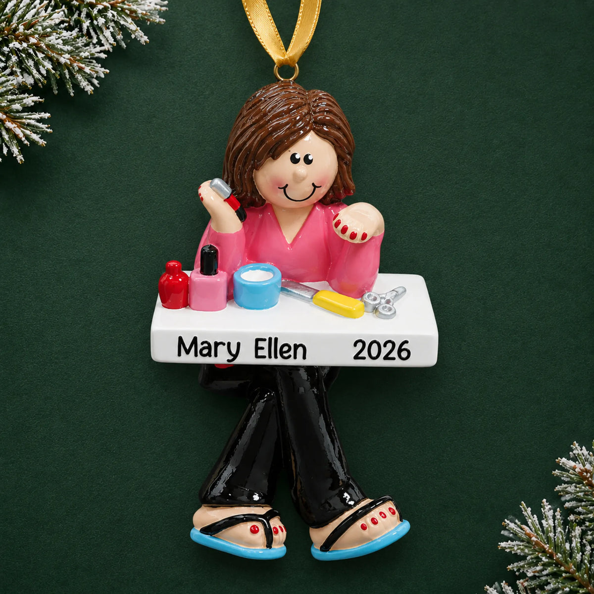 Personalized nail tech christmas ornament on a dark green pine background