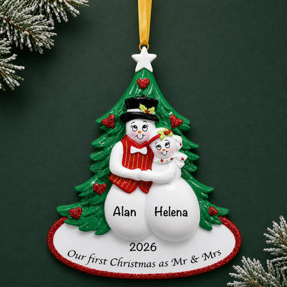 Personalized newlywed snow couple Christmas ornament with a snow couple before a Christmas tree with names and year