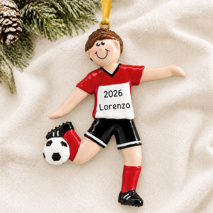 Personalized brunette soccer guy christmas ornament laid on a soft white knit blanket