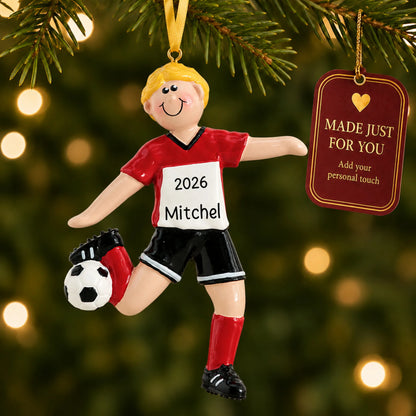 Blonde soccer guy christmas ornament hanging on a lit Christmas tree with a Made Just For You gift tag
