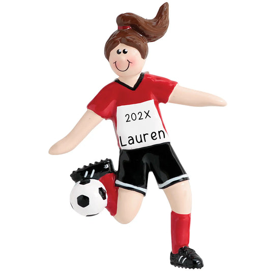 A brunette girl soccer player in a red and white uniform with a soccer ball and shin guards.