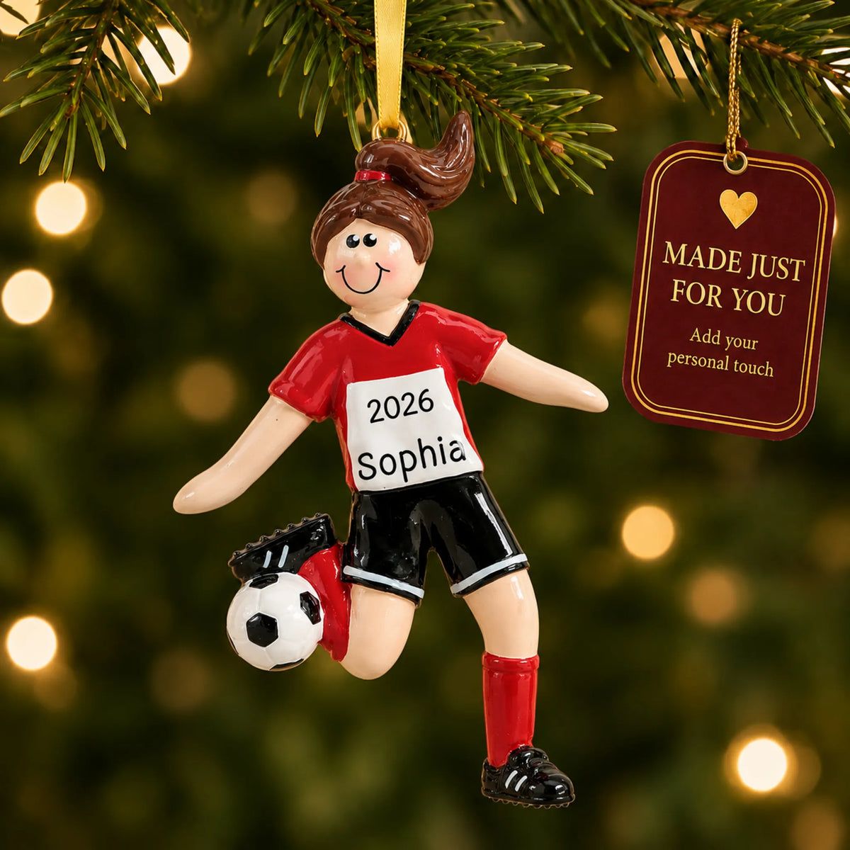 Brunette soccer girl christmas ornament hanging on a lit Christmas tree with a Made Just For You gift tag