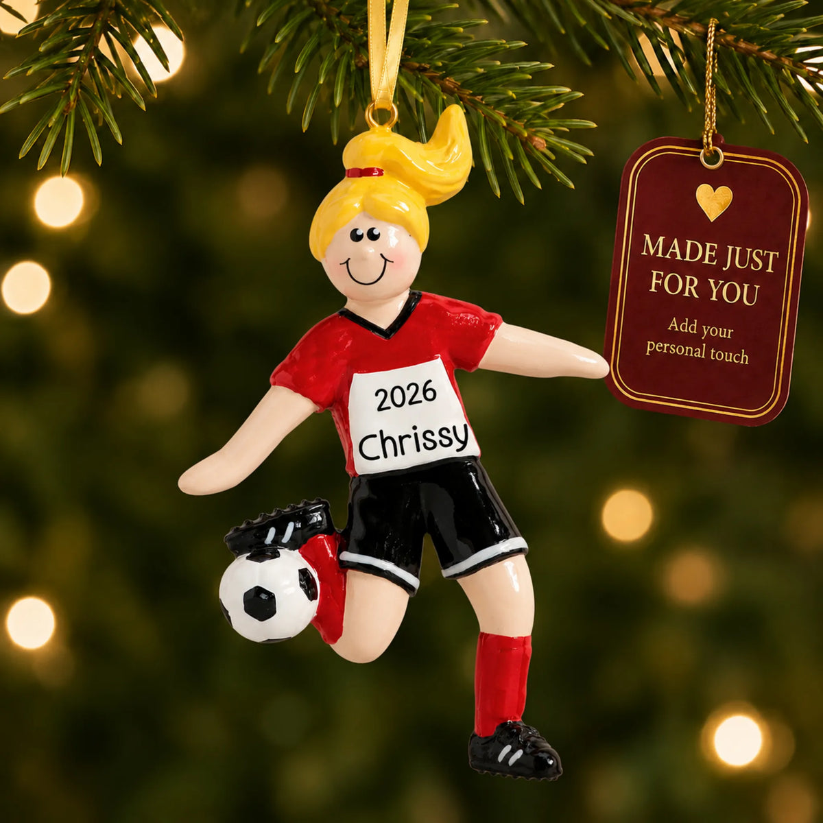 Blonde soccer girl christmas ornament hanging on a lit Christmas tree with a Made Just For You gift tag