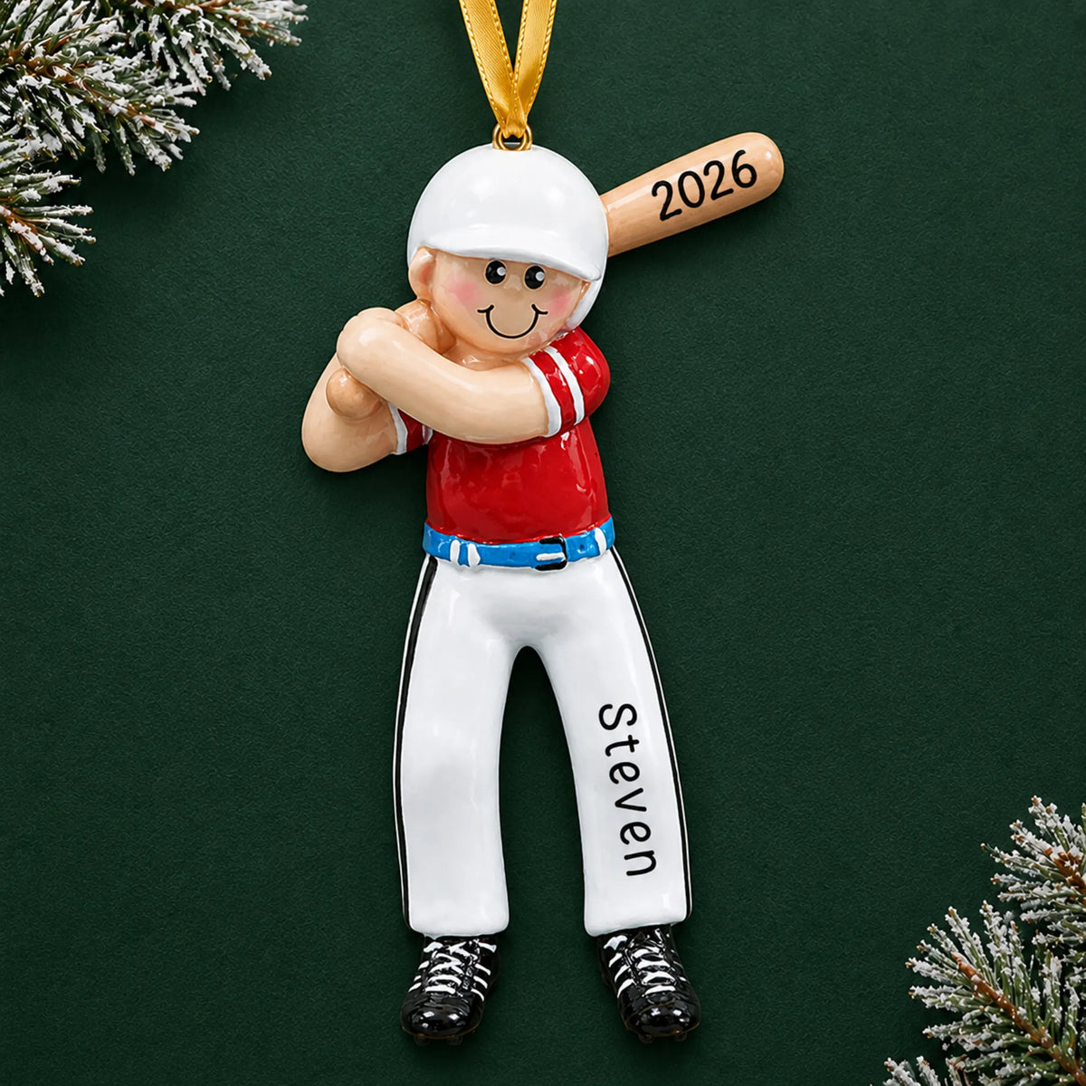Personalized baseball boy batter christmas ornament on a dark green pine background