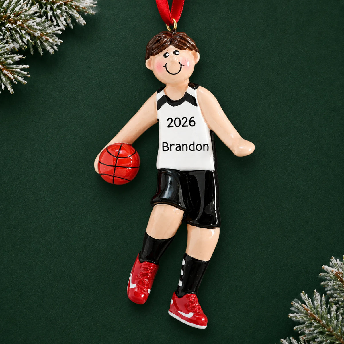 Personalized basketball boy christmas ornament on a dark green pine background