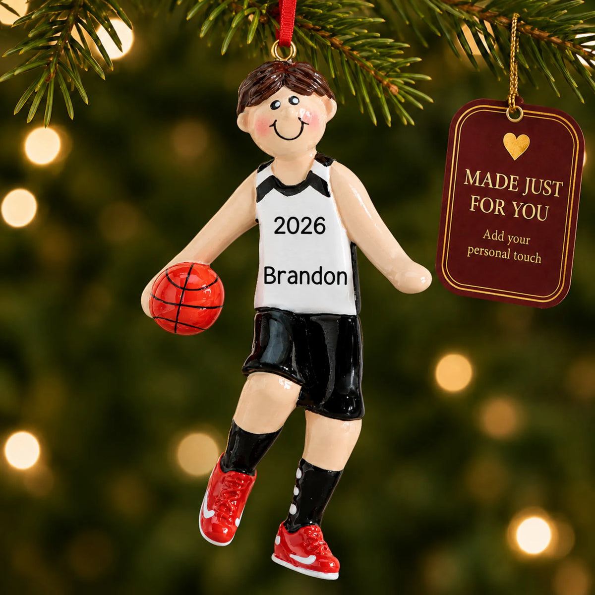 Basketball boy christmas ornament hanging on a lit Christmas tree with a Made Just For You gift tag