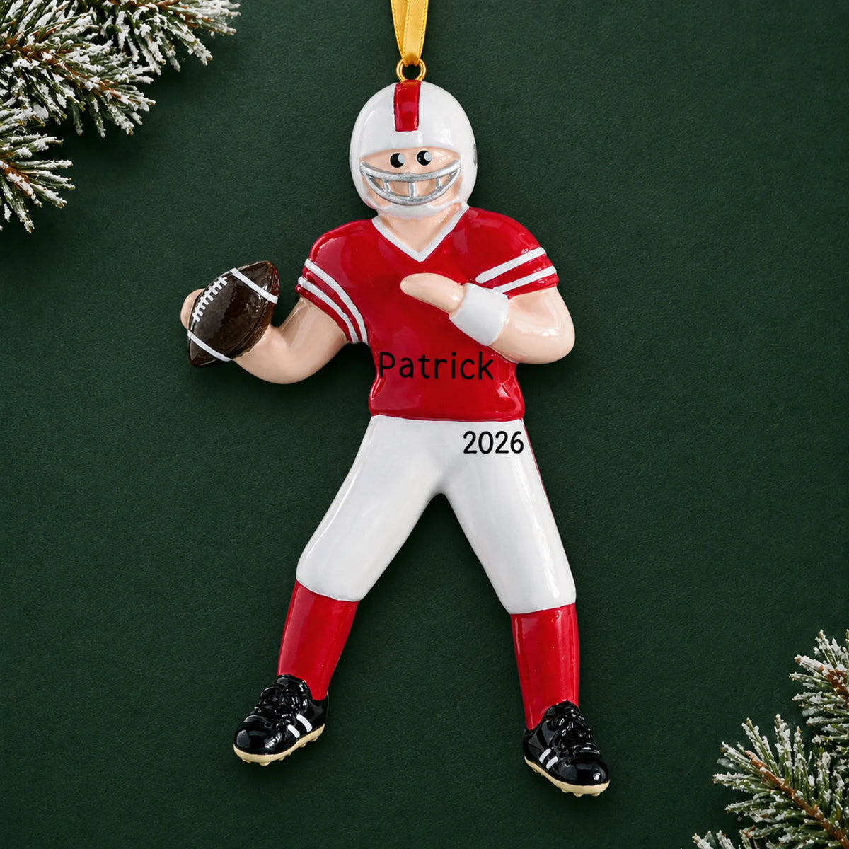 Personalized football boy christmas ornament on a dark green pine background