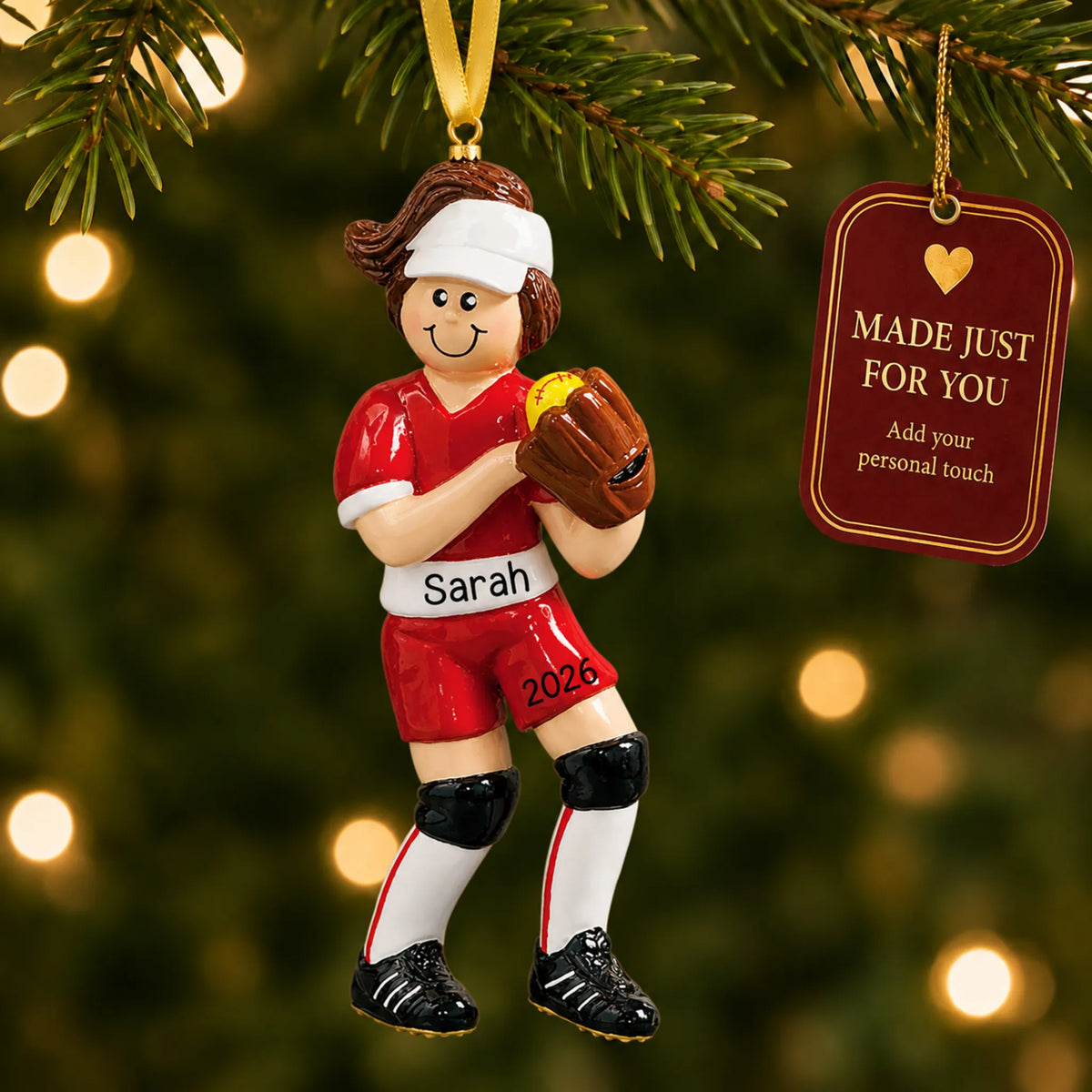 Softball girl christmas ornament hanging on a lit Christmas tree with a Made Just For You gift tag
