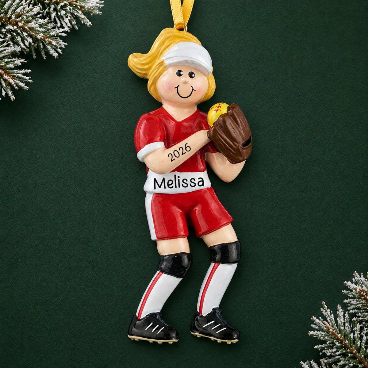 Personalized blonde softball girl christmas ornament on a dark green pine background