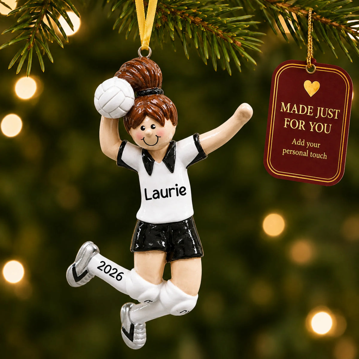 Volleyball girl christmas ornament hanging on a lit Christmas tree with a Made Just For You gift tag