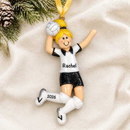 Personalized blonde volleyball girl christmas ornament laid on a soft white knit blanket