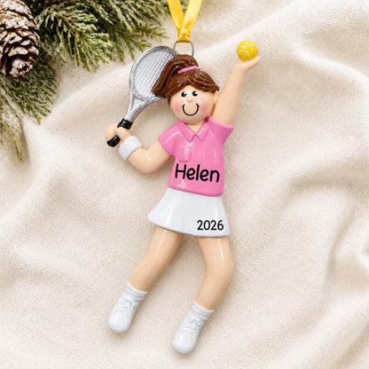Personalized tennis girl christmas ornament laid on a soft white knit blanket