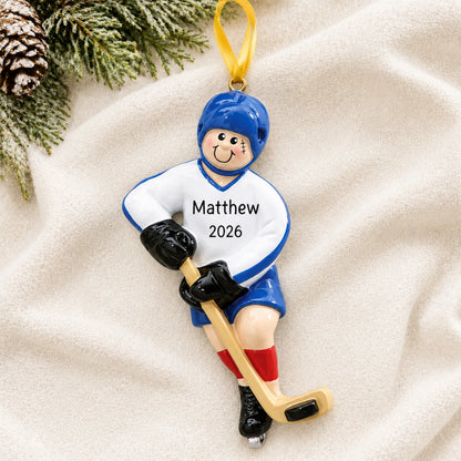 Personalized ice hockey boy christmas ornament laid on a soft white knit blanket