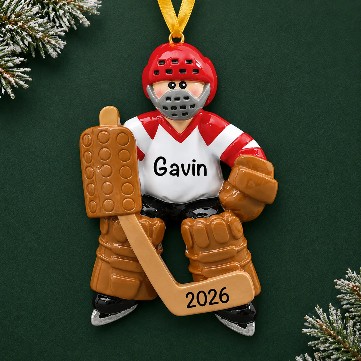 Personalized ice hockey goalie christmas ornament on a dark green pine background