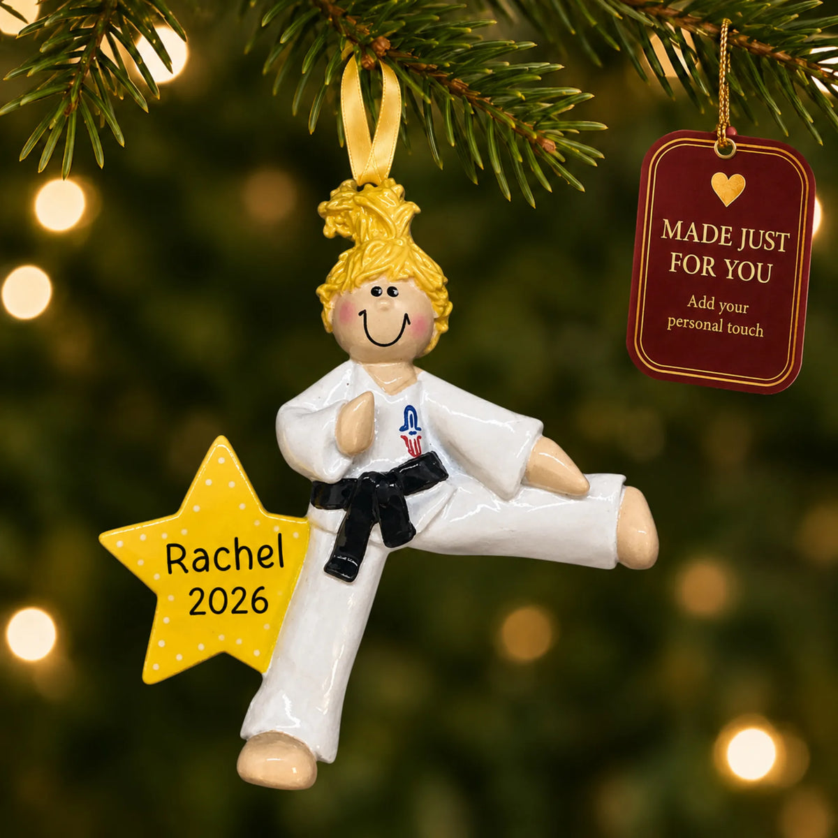 Blonde karate girl christmas ornament hanging on a lit Christmas tree with a Made Just For You gift tag