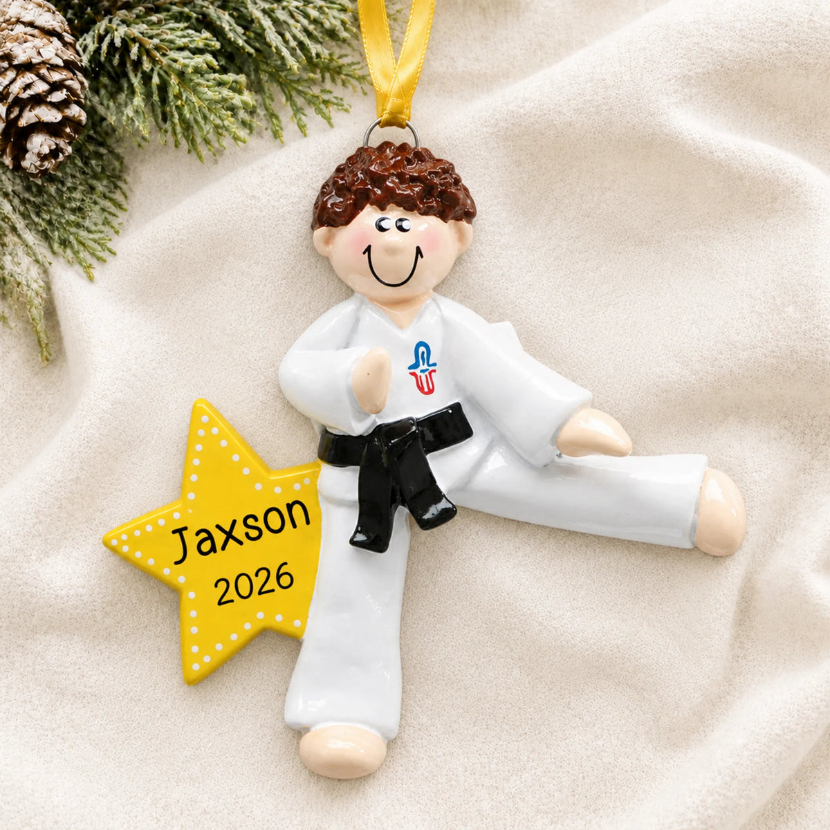 Personalized karate MMA guy christmas ornament laid on a soft white knit blanket