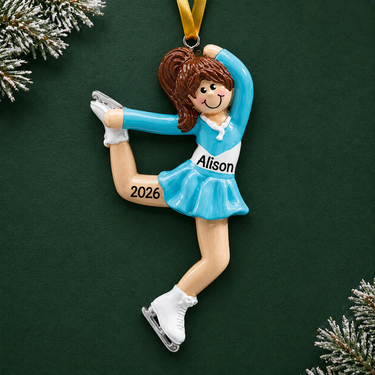 Personalized girl ice skater christmas ornament on a dark green pine background