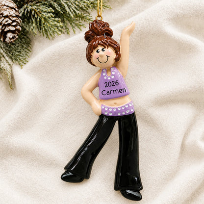 Personalized brunette dance girl christmas ornament laid on a soft white knit blanket