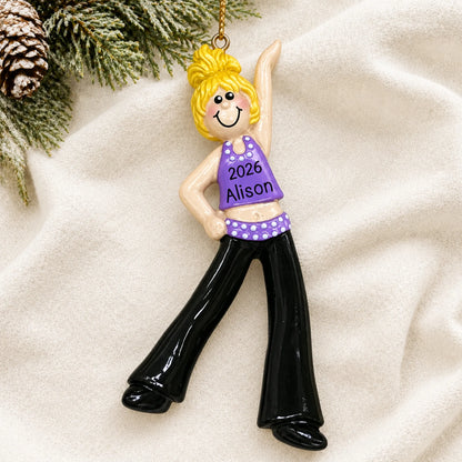 Personalized blonde dance girl christmas ornament laid on a soft white knit blanket