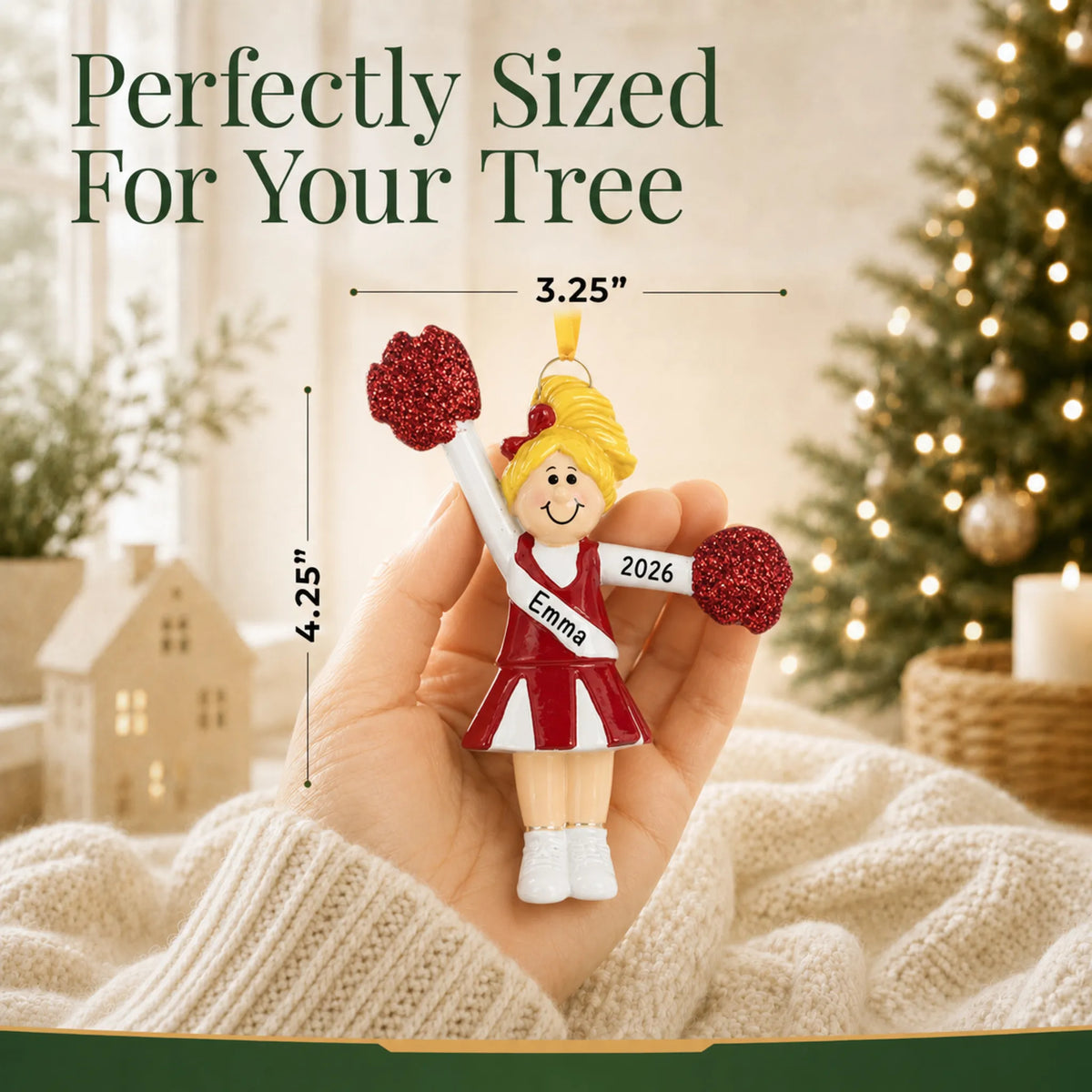 Size guide: the personalized blonde pom pom cheerleader christmas ornament shown in hand next to a Christmas tree
