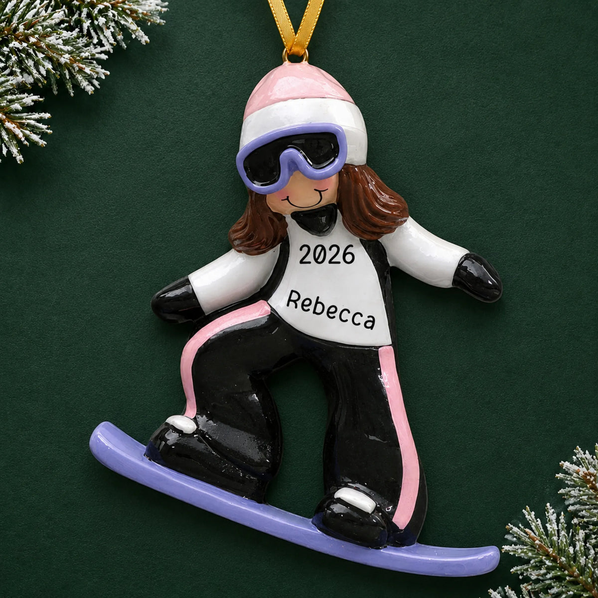 Personalized snowboarding girl christmas ornament on a dark green pine background