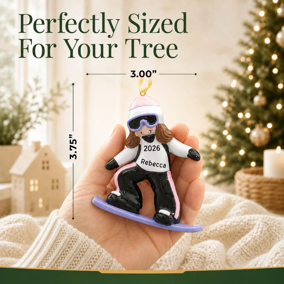 Size guide: the personalized snowboarding girl christmas ornament shown in hand next to a Christmas tree