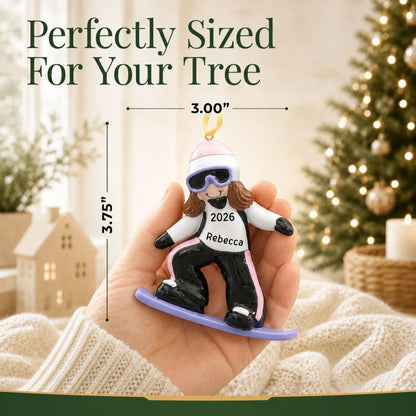 Size guide: the personalized snowboarding girl christmas ornament shown in hand next to a Christmas tree