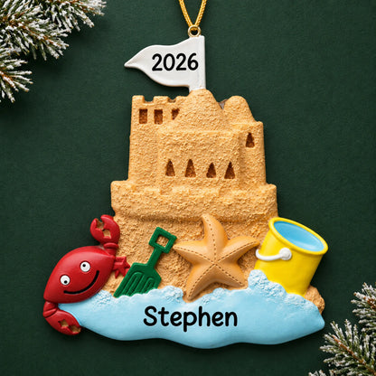 Personalized sand castle beach christmas ornament on a dark green pine background
