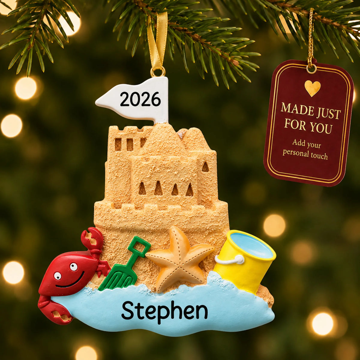 Sand castle beach christmas ornament hanging on a lit Christmas tree with a Made Just For You gift tag
