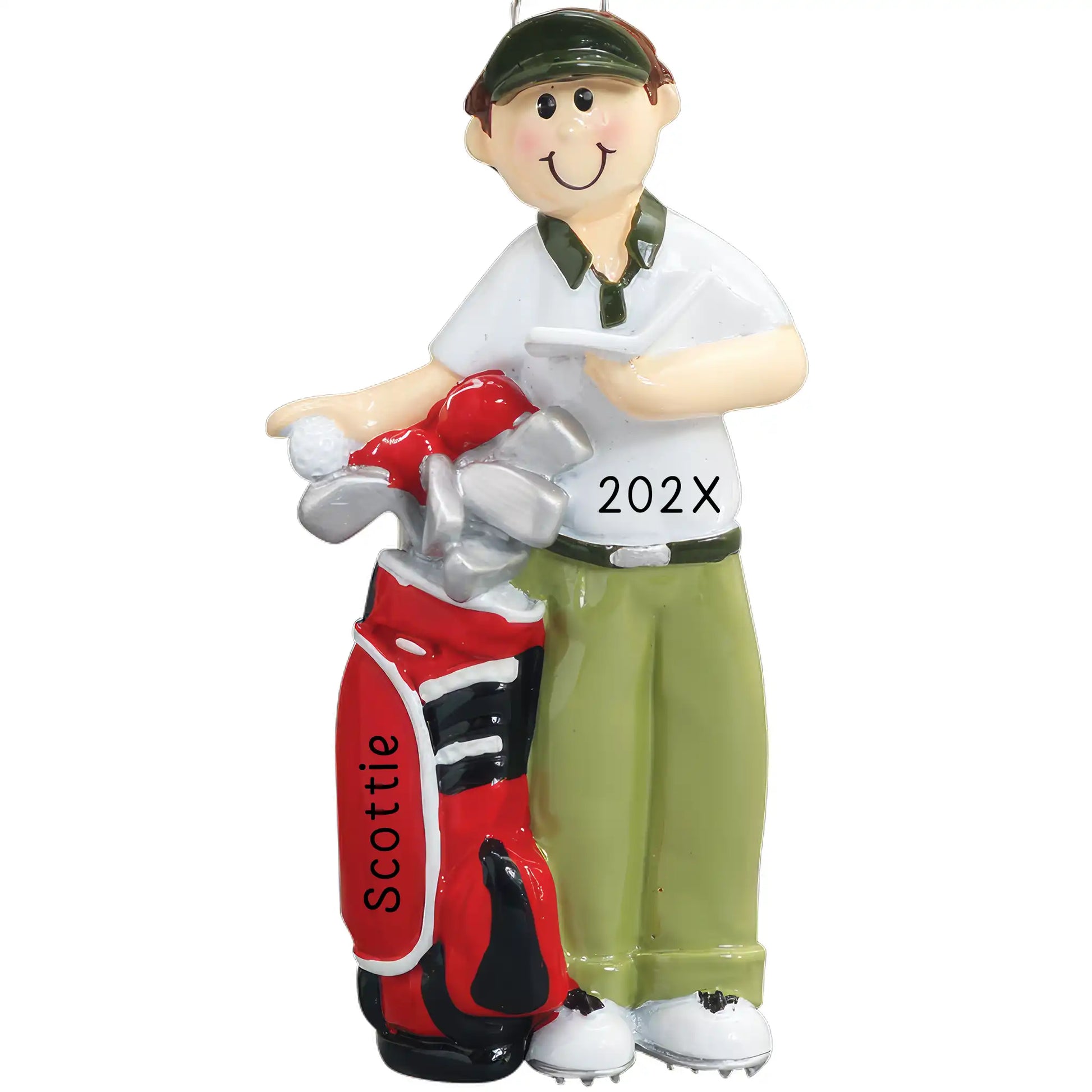 A golf-themed Christmas ornament featuring a happy golfer in khakis and a polo shirt, holding a golf club and a scorecard, with 'YEAR' and a name 'Scottie' on the red golf bag.
