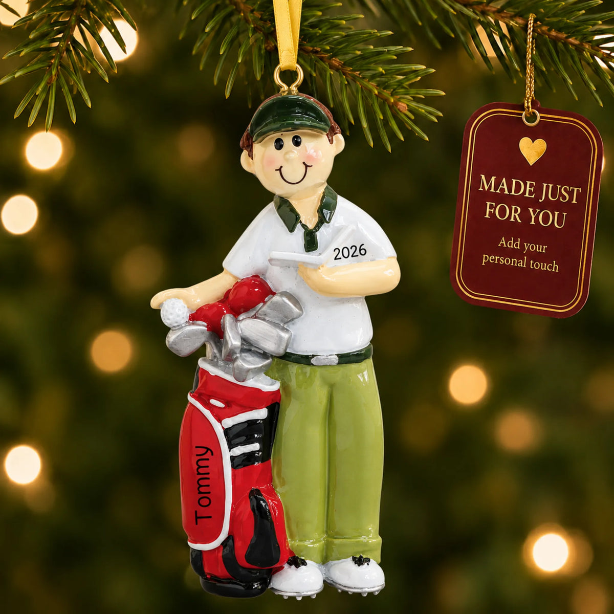 Golfer christmas ornament hanging on a lit Christmas tree with a Made Just For You gift tag