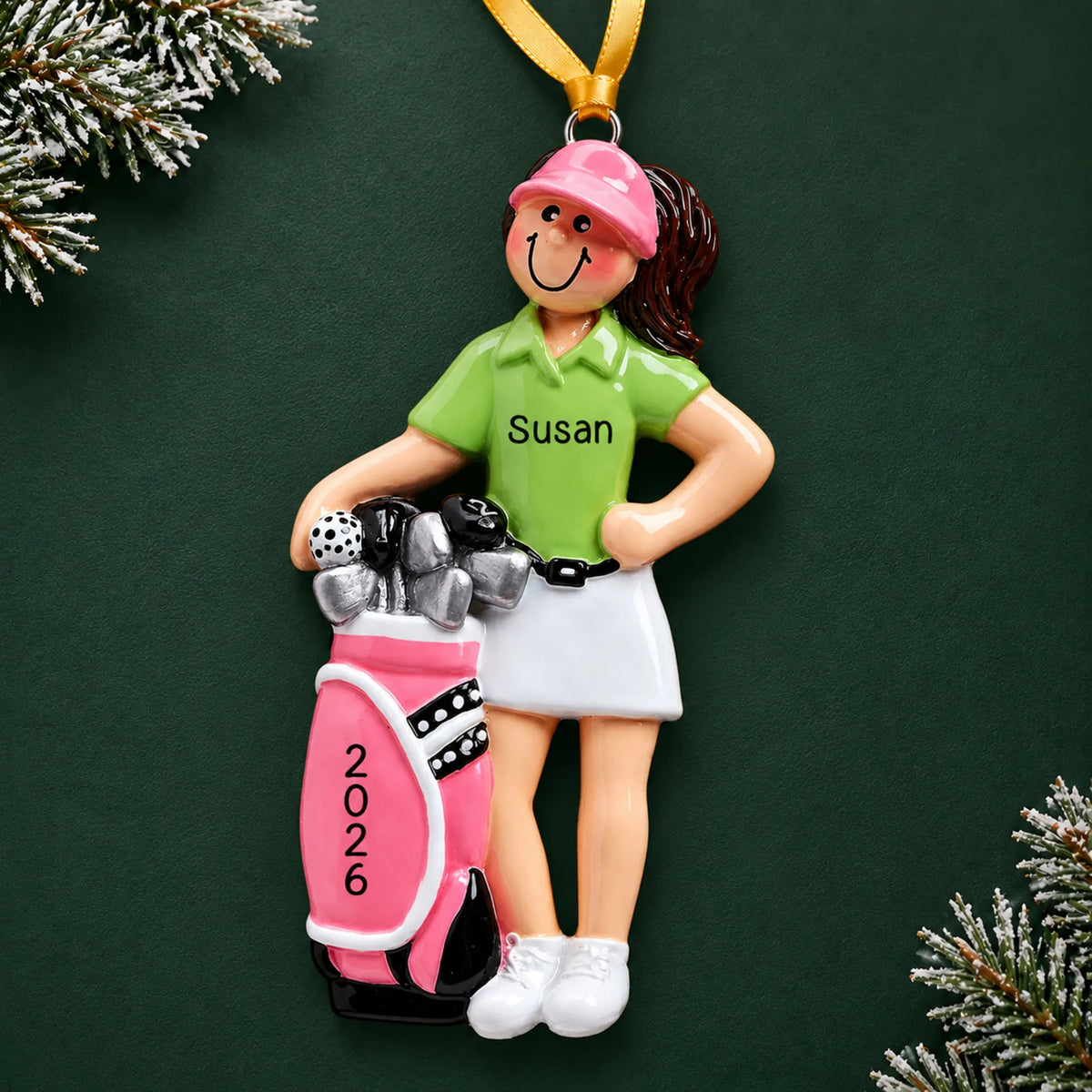 Personalized girl golfer christmas ornament on a dark green pine background