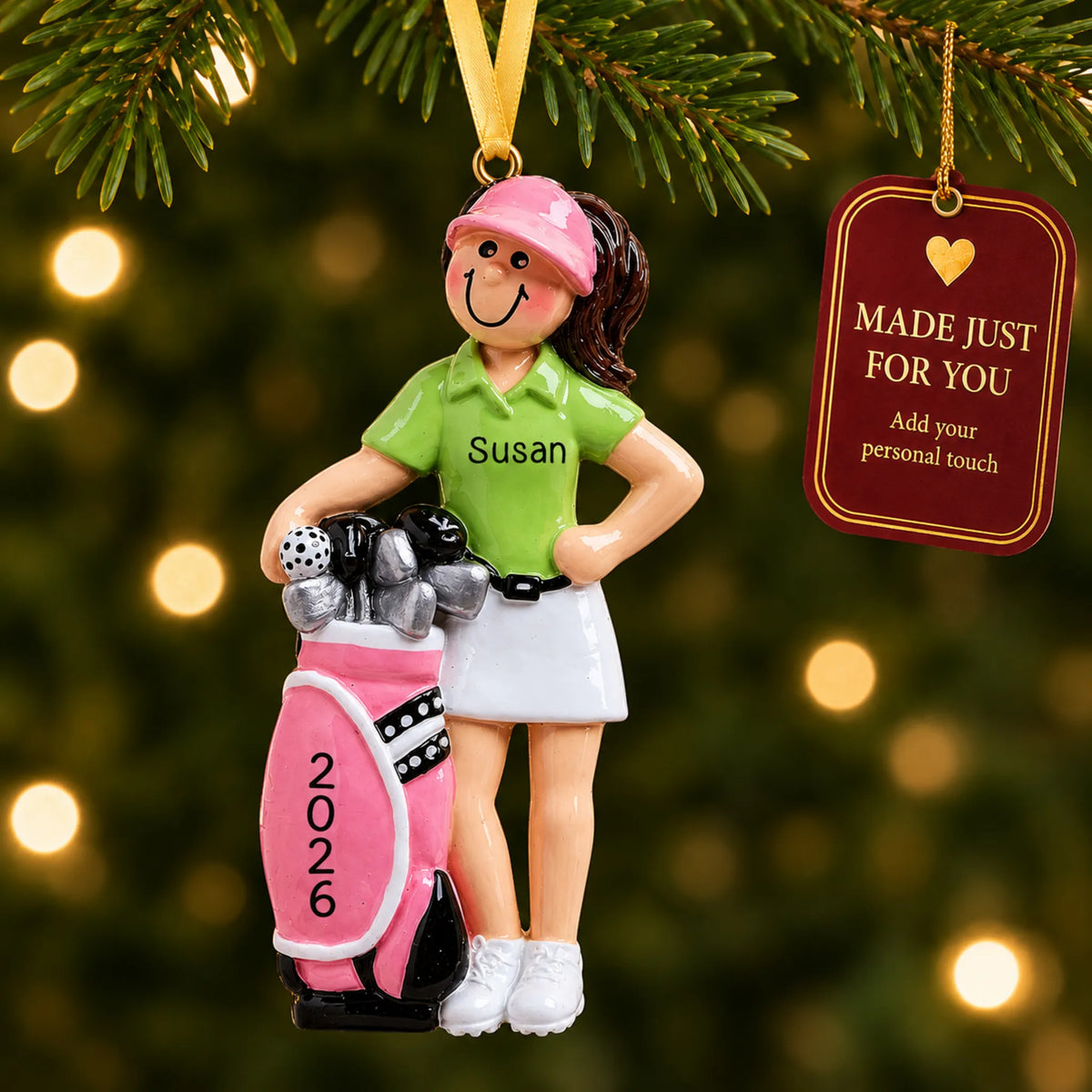 Girl golfer christmas ornament hanging on a lit Christmas tree with a Made Just For You gift tag