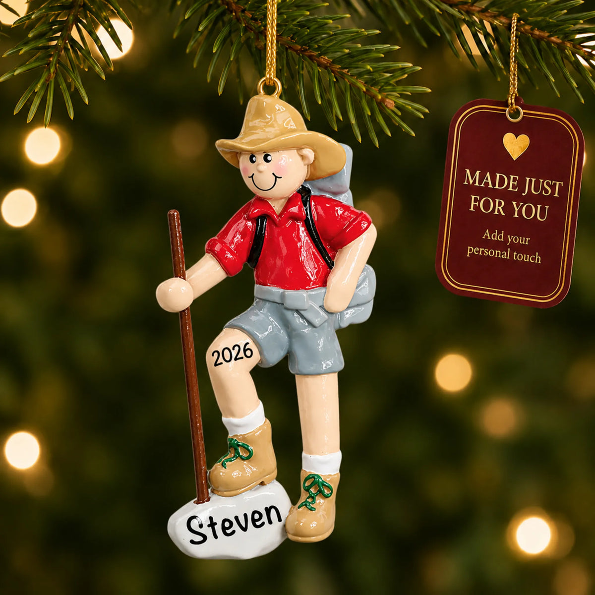 Hiker christmas ornament hanging on a lit Christmas tree with a Made Just For You gift tag