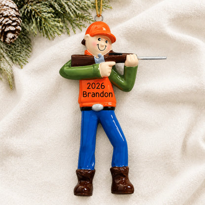 Personalized deer hunter christmas ornament laid on a soft white knit blanket