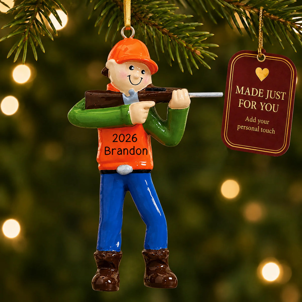Deer hunter christmas ornament hanging on a lit Christmas tree with a Made Just For You gift tag