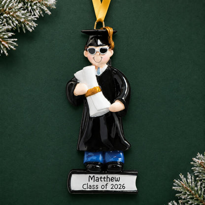 Personalized graduation guy Christmas ornament in cap and gown with sunglasses, holding a diploma, name and class year engraved on the base