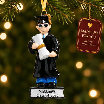 Personalized graduation guy Christmas ornament hanging on a lit tree with a made-just-for-you personalization tag