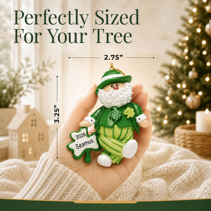 Size guide: the personalized Irish Santa Christmas Leprechaun ornament is 2.75 in wide by 3.25 in tall, shown in hand