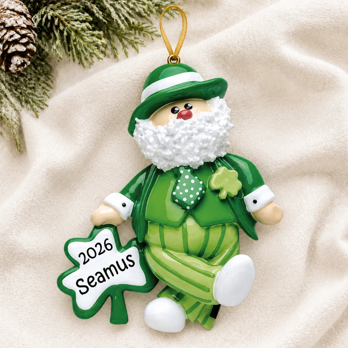 Personalized Irish Santa Christmas Leprechaun ornament laid on a soft white knit blanket