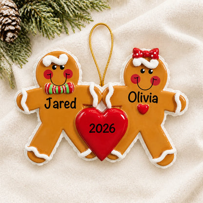 Personalized gingerbread love couple christmas ornament laid on a soft white knit blanket