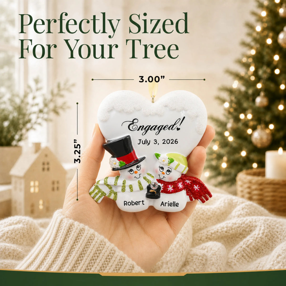 Personalized engaged snow couple Christmas ornament held in a hand to show its 3 by 3.25 inch size