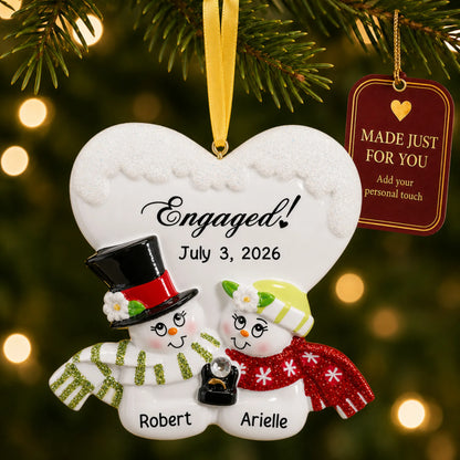 Personalized engaged snow couple Christmas ornament on a lit Christmas tree with a Made Just For You tag