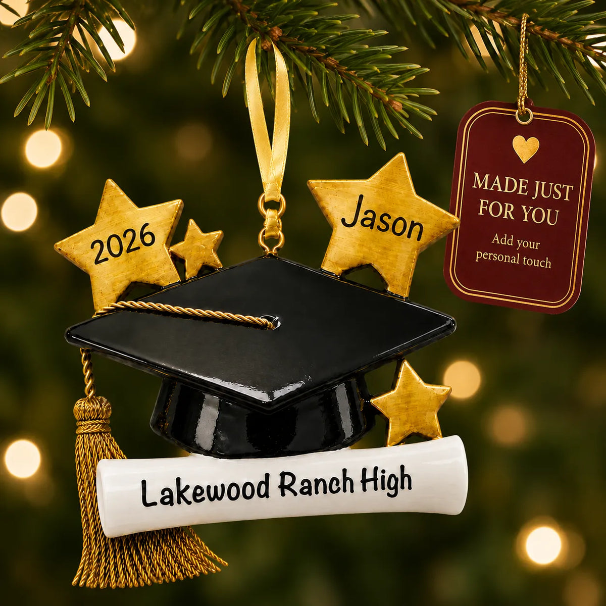 Personalized graduation Christmas ornament with cap and diploma hanging on a tree beside a Made Just For You tag