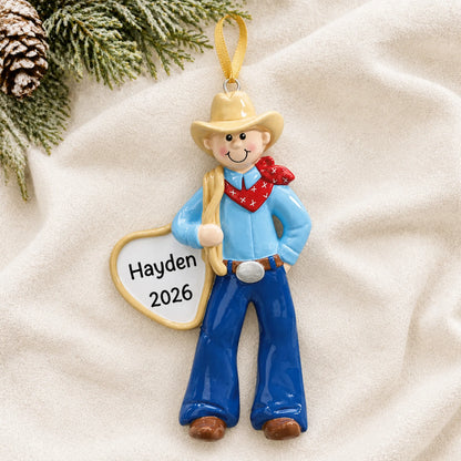 Personalized cowboy rodeo christmas ornament laid on a soft white knit blanket