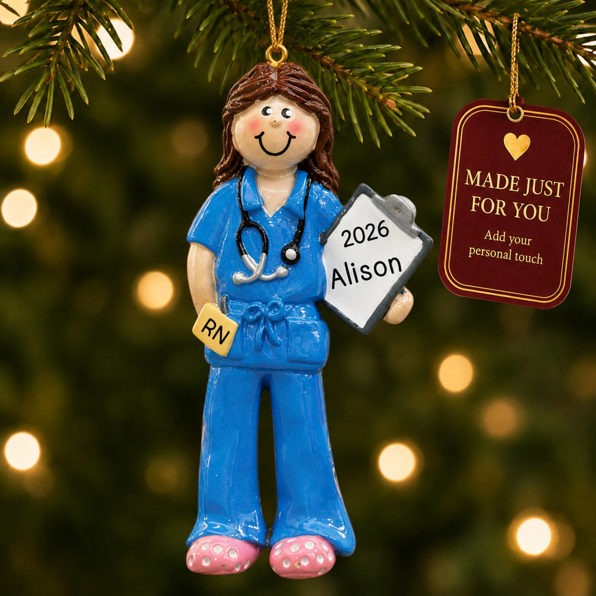 Nurse christmas ornament hanging on a lit Christmas tree with a Made Just For You gift tag