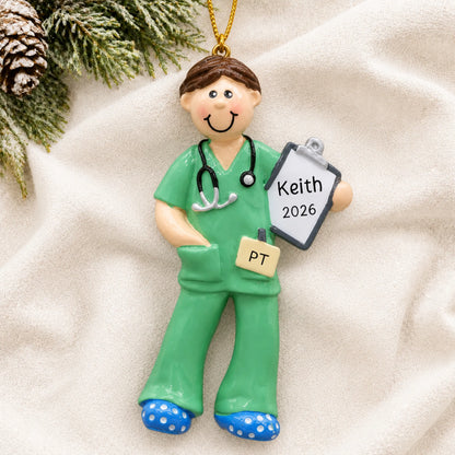 Personalized physical therapist guy christmas ornament laid on a soft white knit blanket