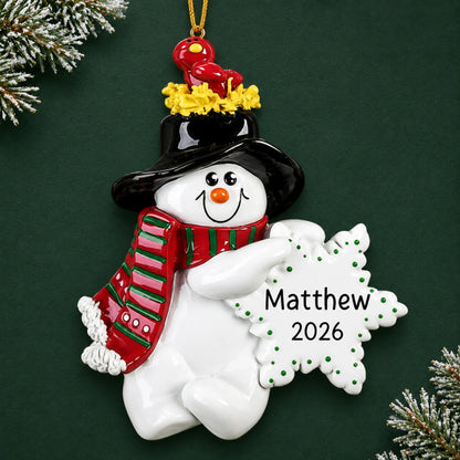 Personalized Birdsnest Snowman christmas ornament on a dark green pine background