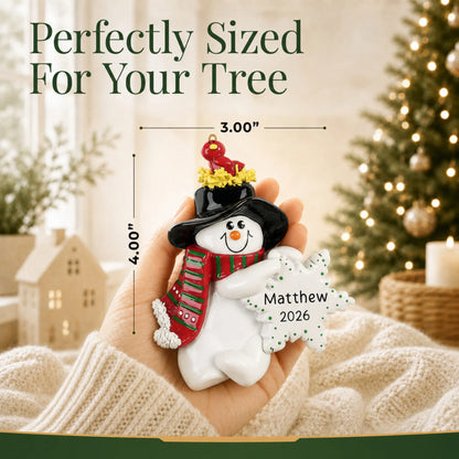 Size guide: the personalized Birdsnest Snowman christmas ornament is 3.00 in wide by 4.00 in tall, shown in hand