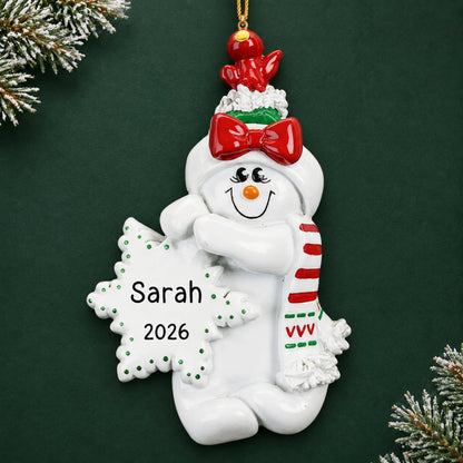 Personalized Birdsnest Snow Woman christmas ornament on a dark green pine background